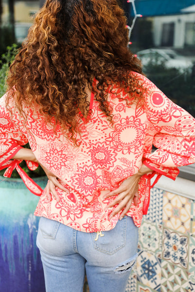 Macarena® | Long sleeve top with bow tie and contrast floral print in red and coral