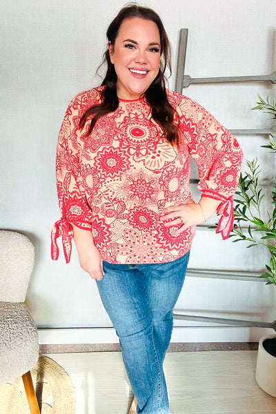 Macarena® | Long sleeve top with bow tie and contrast floral print in red and coral